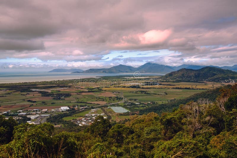 Aerial shot of an agricultural valley under a pink cloudy sky stock photography.