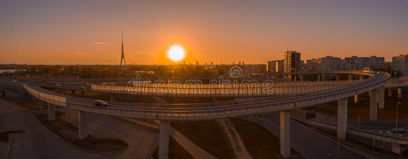 Aerial shot of city buildings and road junctions at sunset stock photography