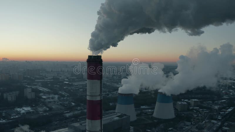 Aerial shot of the cityscape of Moscow in the winter morning behind of industrial smoke stacks. Russia