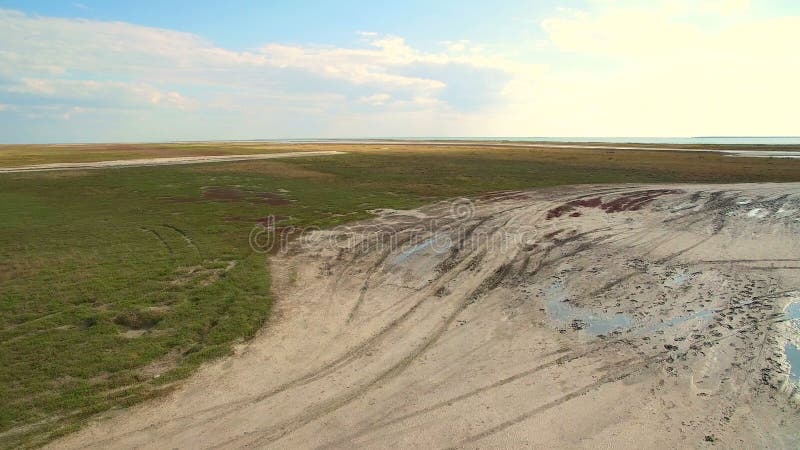 Aerial shot 4k. Jeep rides through the swamp. Dead sea aerial view in Ukraine. Landscape and riches of the sea