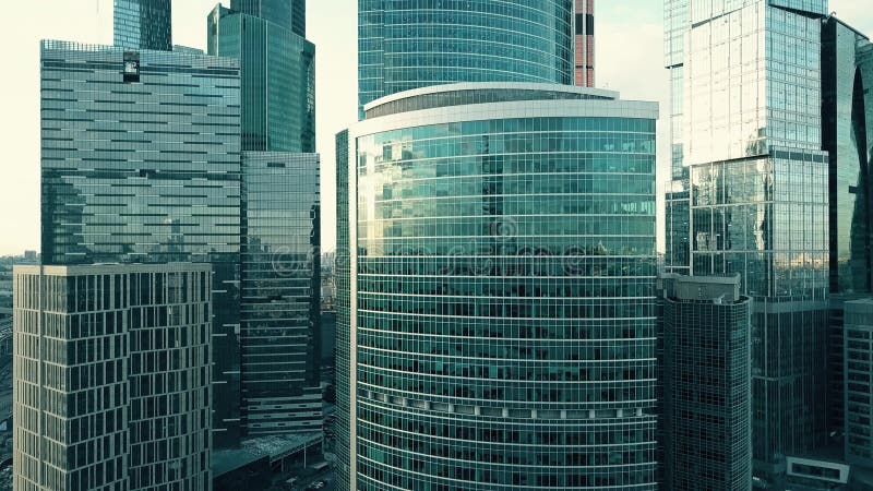 Aerial shot of office skyscraper details reflecting sky and cityscape