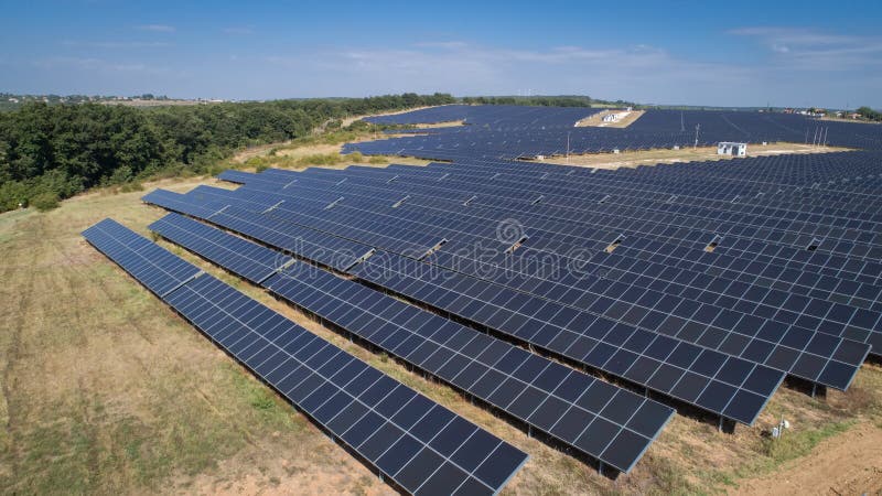 Aerial shot of photovoltaic solar farm. Solar farm power station from above. Ecological renewable energy.