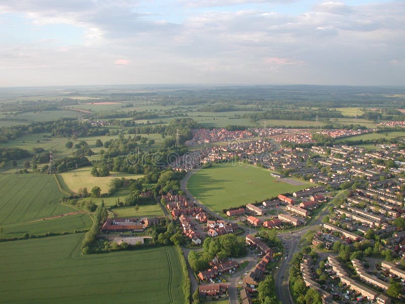 Aerial shot of town in countryside with fields