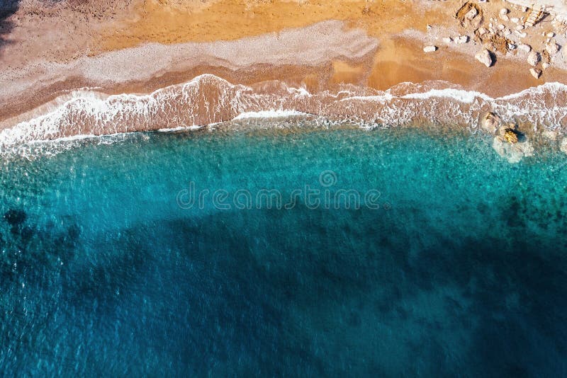 Aerial top view of azure sea waves and sandy beach coast in sunny summer day, drone photo royalty free stock image Aerial top view of azure sea waves and sandy beach coast in sunny summer day, drone photo royalty free stock image
