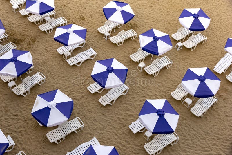 Aerial Top View of a Beach with White Umbrellas and Blue Lounge Chairs ...