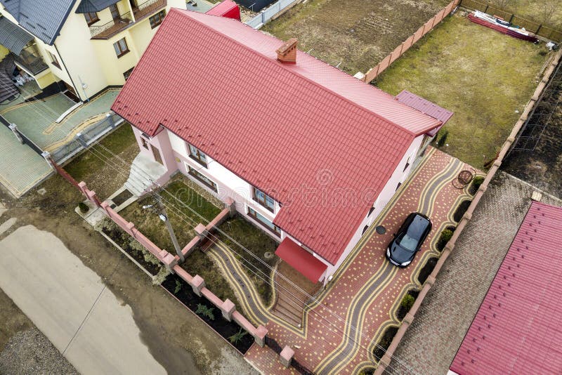 Aerial top view of house with shingle roof and brick chimney in quiet neighborhood, black car on paved yard. Well maintained royalty free stock image Aerial top view of house with shingle roof and brick chimney in quiet neighborhood, black car on paved yard. Well maintained royalty free stock image