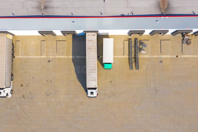 Aerial top view of the large logistics park with warehouse, loading hub with many semi-trailers trucks royalty free stock photography