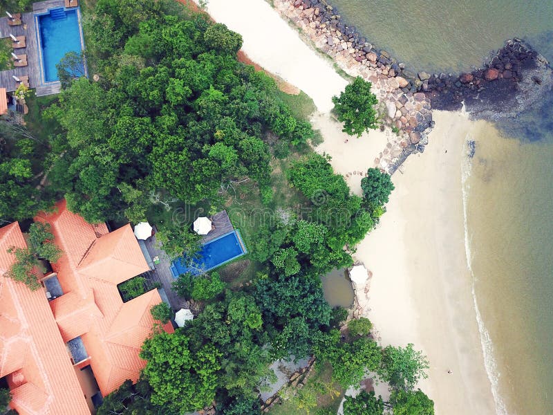 Aerial top view of luxury villa with pool next the beach and ocean