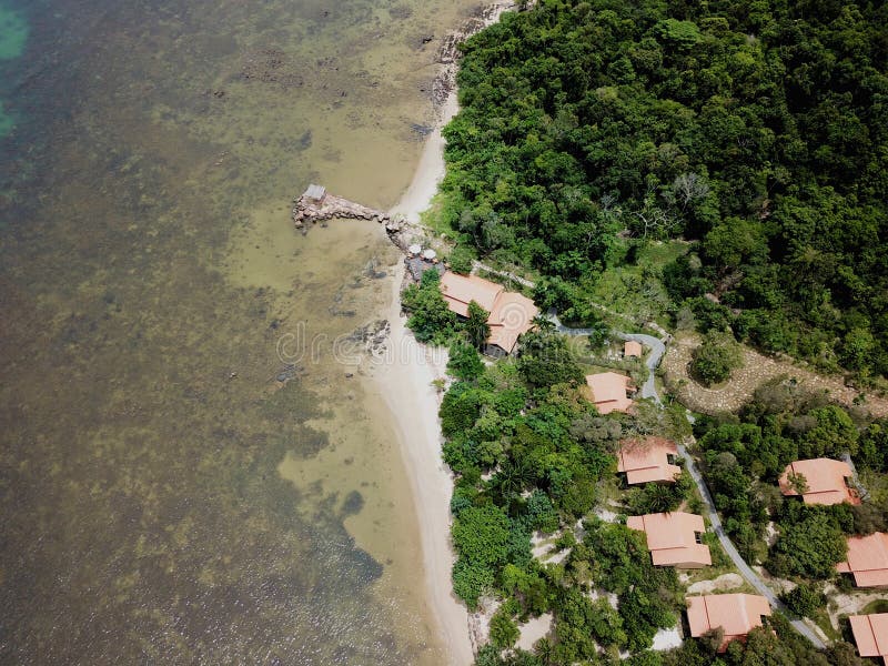 Aerial top view of luxury villa with pool next the beach and ocean