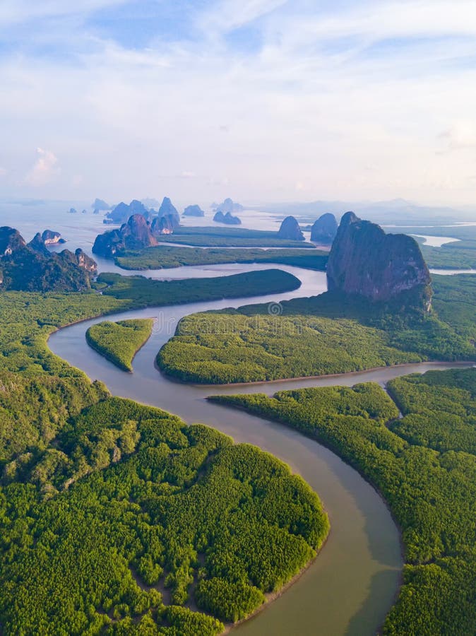 Aerial top view of Samet Nangshe and tropical green forest trees at sunset with Andaman sea in Phang Nga Bay in summer, Thailand