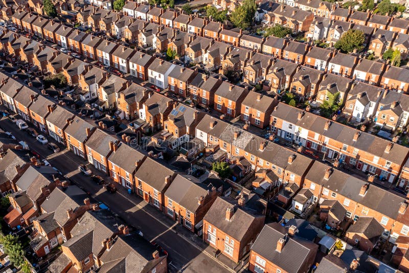 Aerial view above rows of back to back terraced houses on a large council estate