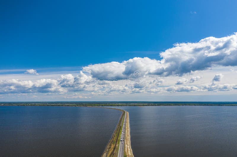 Aerial view of the amazing big river with dam under beautiful cloudy blue sky. Europe, Ukraine, Kremenchuk Reservoir, Dnieper or