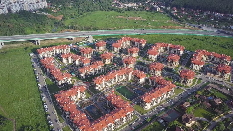 Aerial view apartment buildings complex and residential houses neighborhood. Clip. Top view of the modern luxery