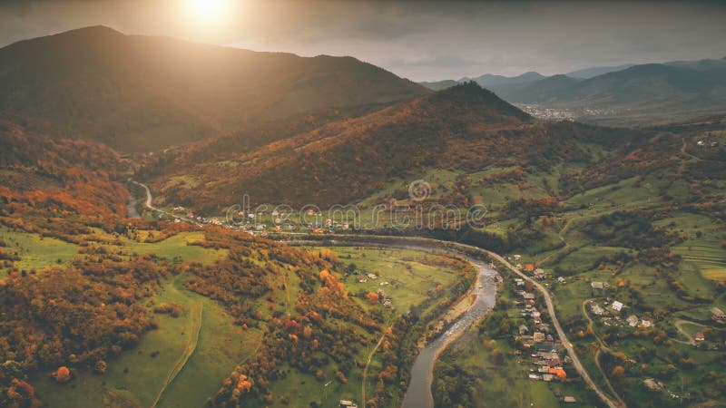 Aerial View: autumn canyon village along the river