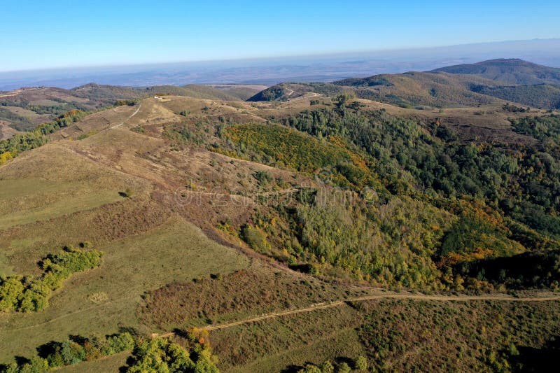 Aerial view of autumn hills and colorful forest royalty free stock images