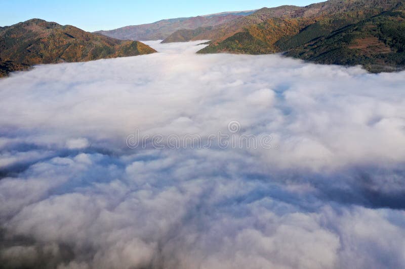 Aerial view of autumn morning mist and clouds in the valley royalty free stock photography