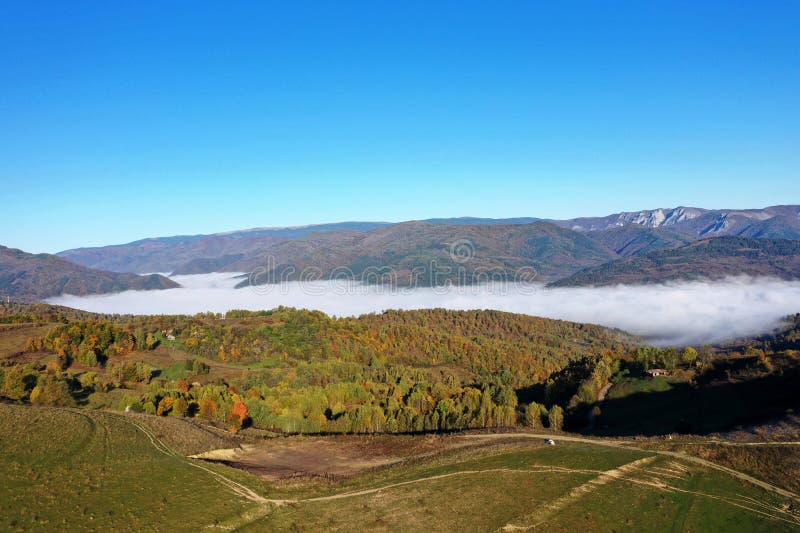 Aerial view of autumn morning mist and clouds in the valley royalty free stock photography
