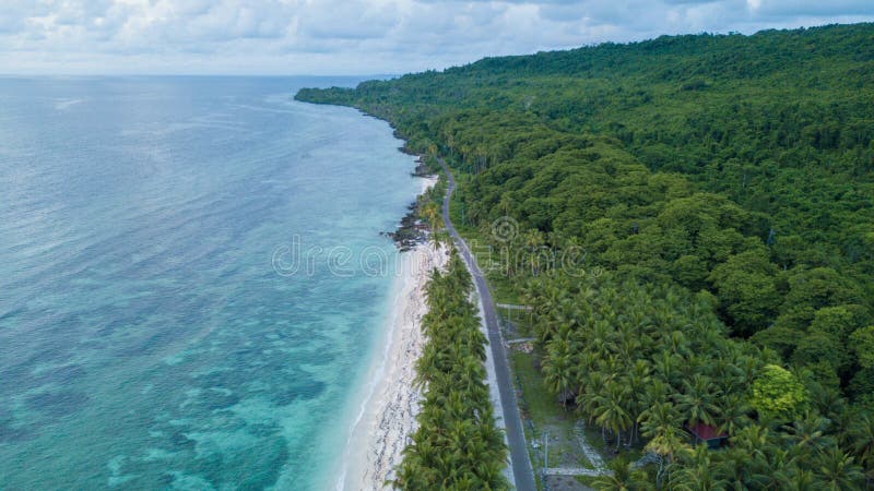Aerial view of the beach near highway with nice sky and blue ocean