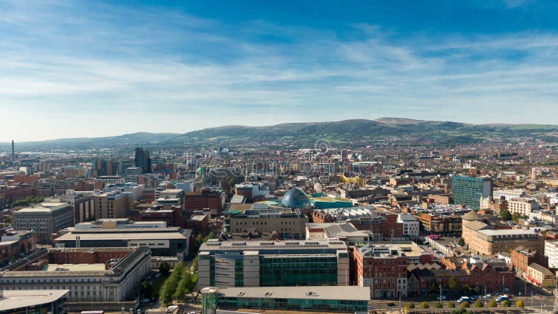 Aerial view of Belfast in Northern Ireland at Night. Sunset above City, mountains or hills on backgroundFootpath between trees in stock photography Aerial view of Belfast in Northern Ireland at Night. Sunset above City, mountains or hills on backgroundFootpath between trees in stock photography
