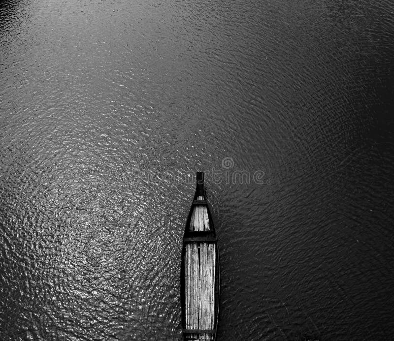 Aerial View Black Wooden Row Boat on Body of Water royalty free stock images Aerial View Black Wooden Row Boat on Body of Water royalty free stock images