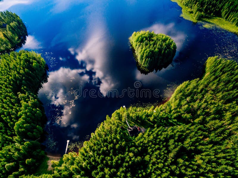 Aerial view of blue lake with island and green forests on a sunny summer day in Finland. royalty free stock images Aerial view of blue lake with island and green forests on a sunny summer day in Finland. royalty free stock images