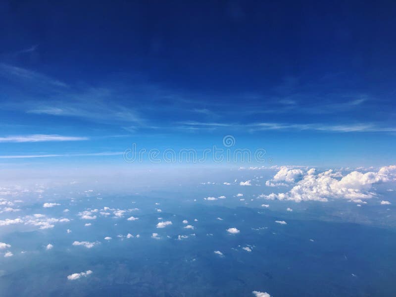 Aerial view of blue sky and cloud top view from airplane window.