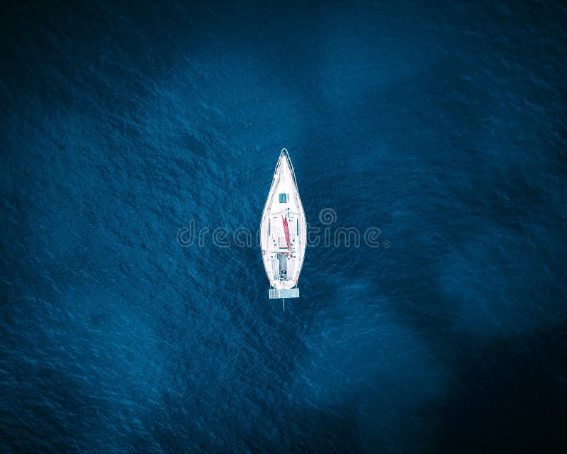 Aerial view of a boat in the blue sea royalty free stock photography