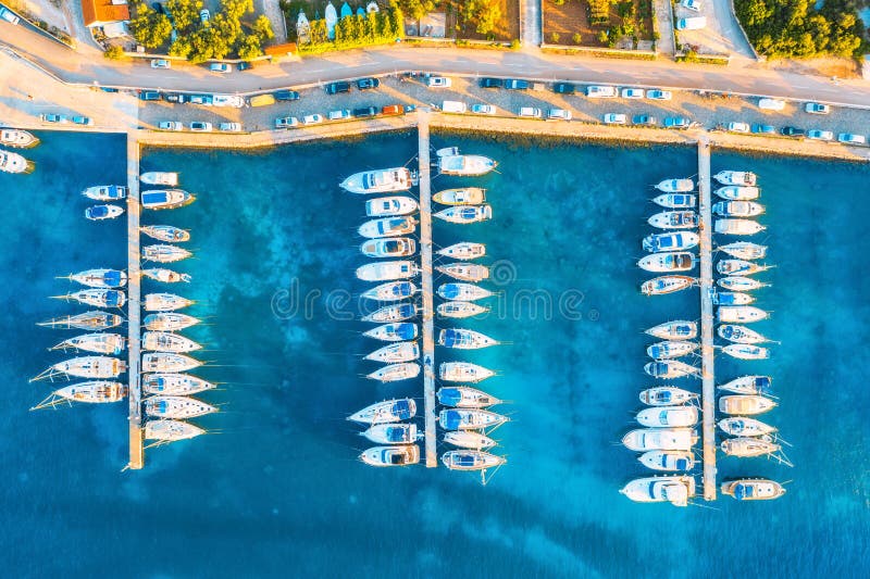 Aerial view of boats and yachts in port in old city at sunset