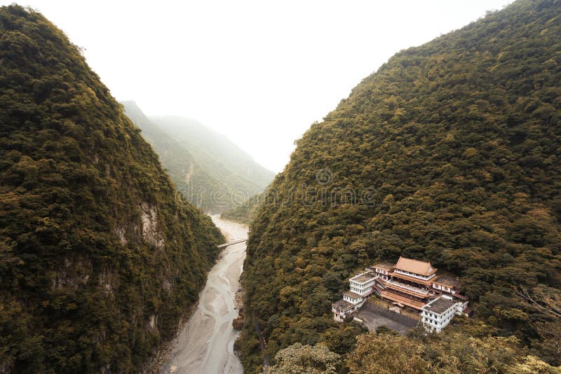 Aerial view of a Buddhist temple hidden in a deep valley of Taiwan