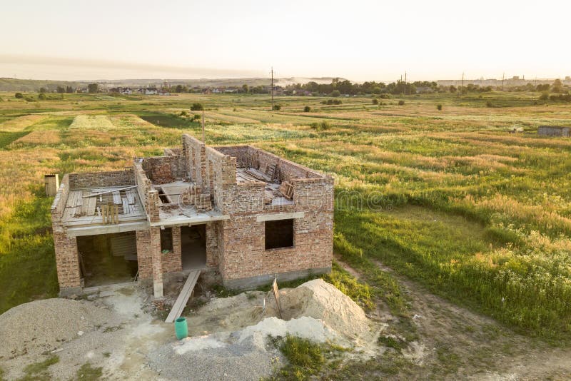 Aerial view of building site for future house, brick basement floor and stacks of brick for construction royalty free stock image
