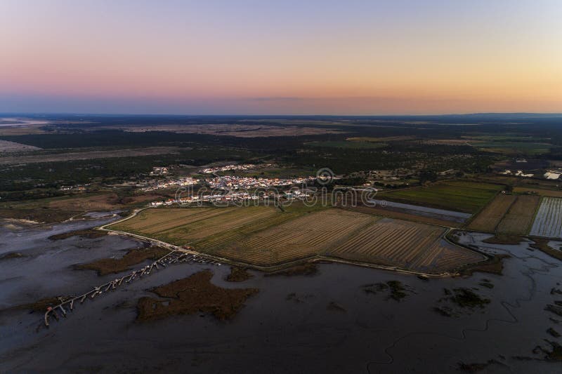 Aerial view of the Carrapateira village with the Sado estuary, the palafitic pier and the surrounding rice paddy fields