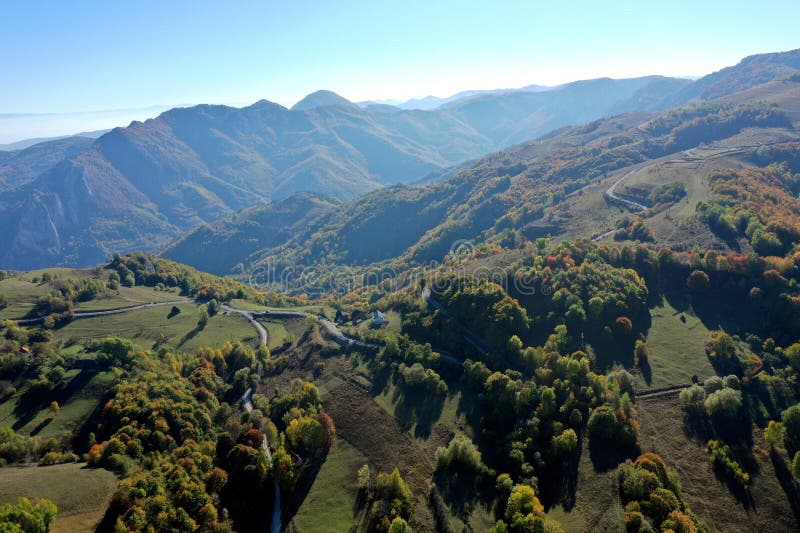 Aerial view of colorful autumn forest covered mountains in the autumn royalty free stock image