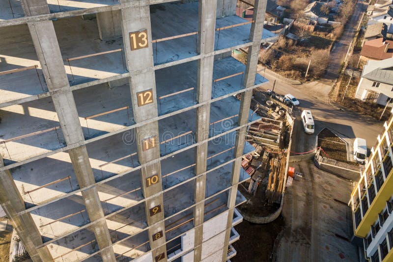 Aerial view of concrete frame of tall apartment building under construction in a city