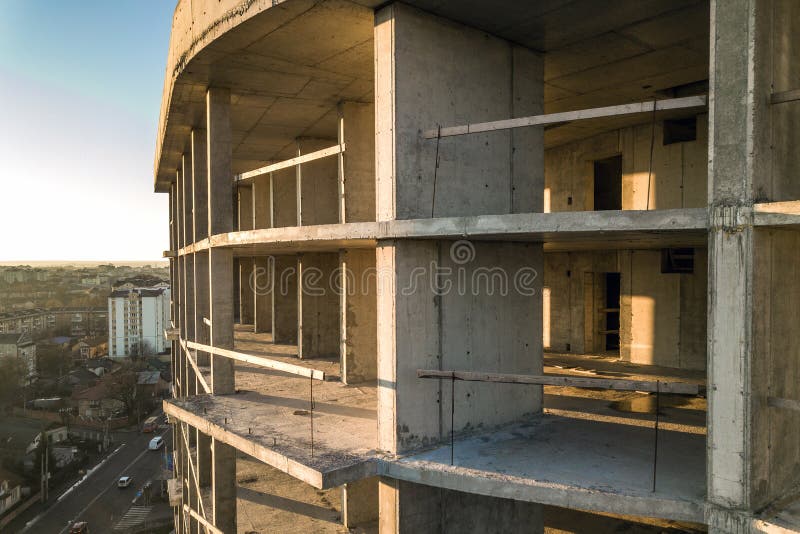 Aerial view of concrete frame of tall apartment building under construction in a city