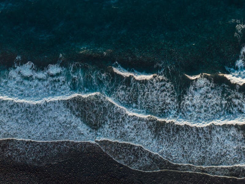 Aerial view of crashing waves on rocks