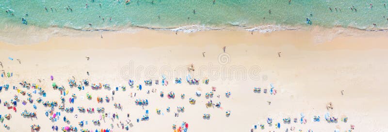 Aerial view crowded public beach with colourful umbrellas, Aerial view of sandy beach with tourists swimming in beautiful clear sea waterà¹ƒ