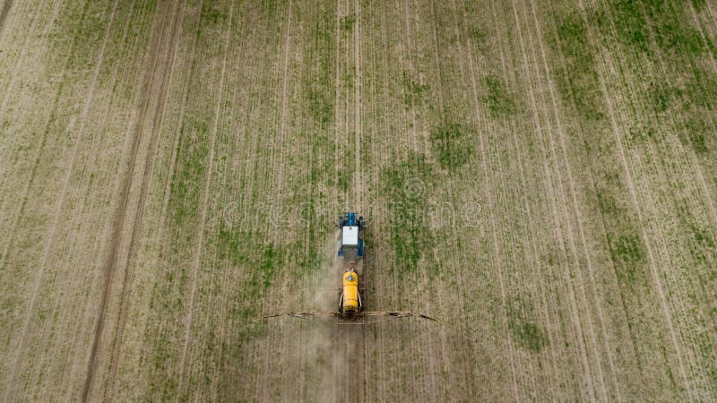 Aerial view of farming tractor plowing and spraying on field royalty free stock photos Aerial view of farming tractor plowing and spraying on field royalty free stock photos