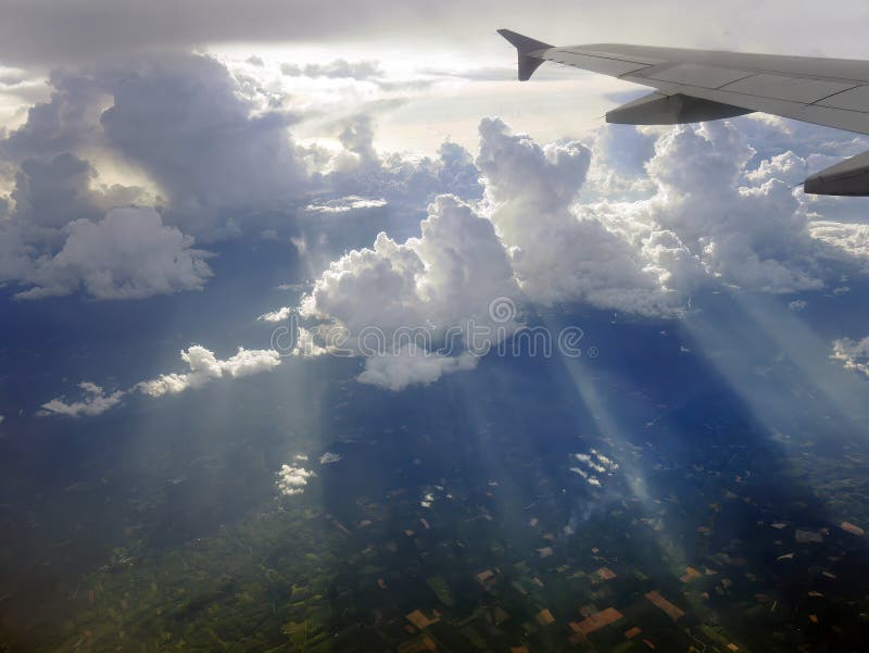 Aerial view flying above dramatic fluffy clouds and sun rays piercing shining through the clouds, cloudscape, sunlight stock images
