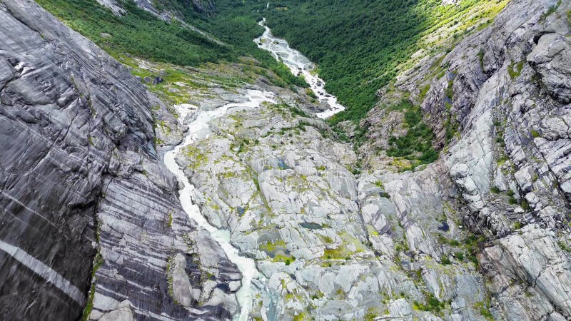 Aerial view of glacial meltwater and streams through rugged rock formation in Brenndalsbreen, Norway stock footage