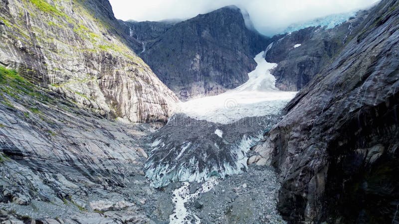 Aerial view of glacial meltwater and streams through rugged rock formation in Brenndalsbreen, Norway stock video