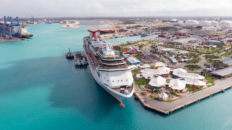 Aerial View on Grand Cruise Ship in Freeport in Grand Bahama. Drone view on Freeport landscape. Cruise Ship staying in port dock. royalty free stock photography