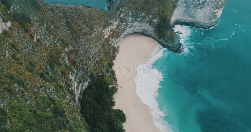 Aerial view happy couple making drone footage of amazing Kelingking Beach at Nusa Penida island, Bali