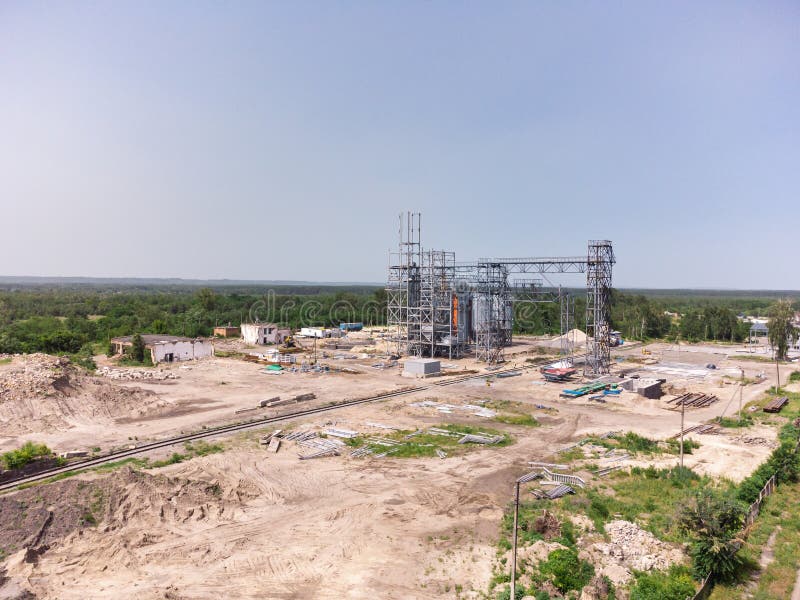 Aerial view of huge modern grain elevator. Food storage, building in progress. Silo farm. Agribusiness development