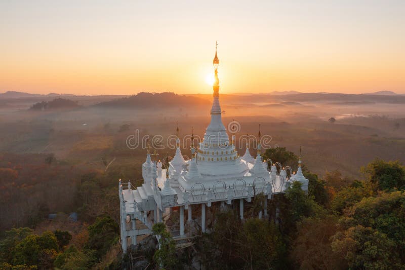 Aerial view of Khao Na Nai pagoda stupa. Luang Dharma Temple Park with green mountain hills and forest trees, Surat Thani