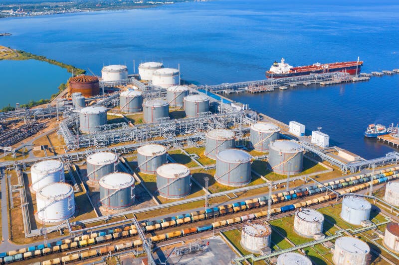 Aerial view of large fuel storage tanks at oil refinery industrial zone in the cargo seaport, and ship tanker at unloading royalty free stock image Aerial view of large fuel storage tanks at oil refinery industrial zone in the cargo seaport, and ship tanker at unloading royalty free stock image