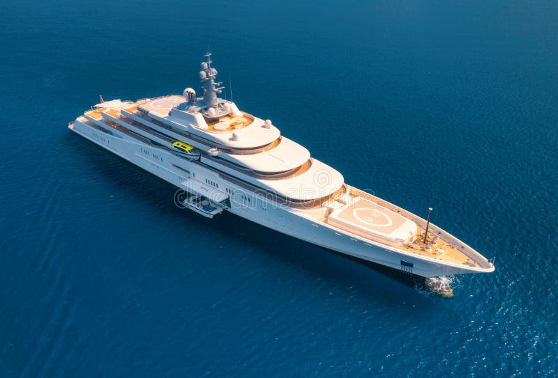 Aerial view of luxury yacht and blue sea at sunny bright day