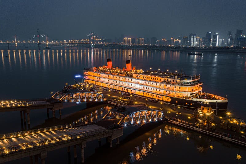 Aerial view of the majestic Wuhan Zhiyin cruise ship by the Yangtze River, China at night.