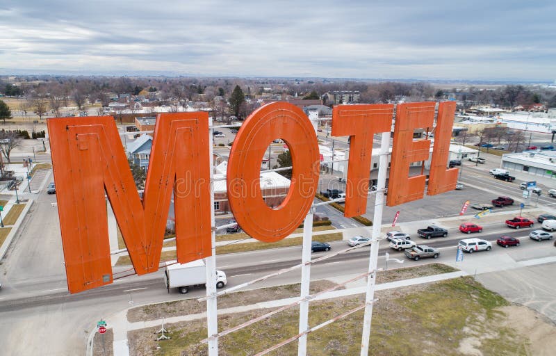 Aerial View of a Motel Sign with the Backdrop of a City Stock Photo