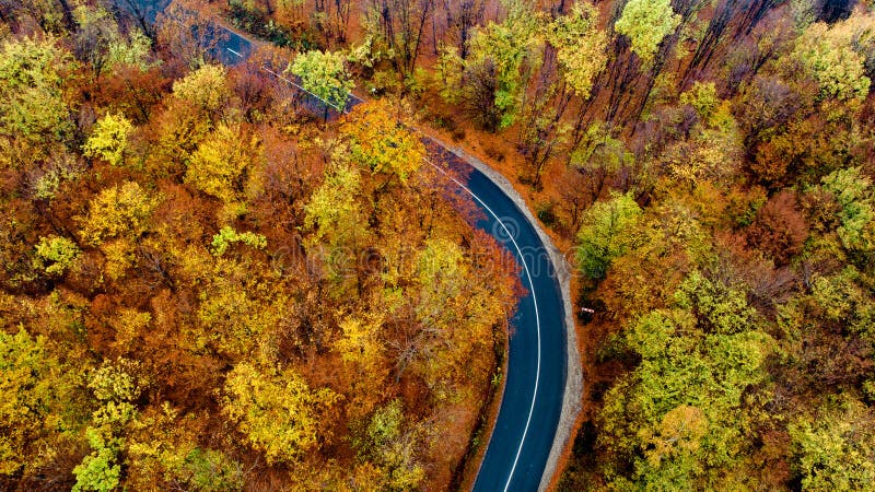 Aerial view of mountain curved road with no traffic. Asphalt serpentine roads details stock image Aerial view of mountain curved road with no traffic. Asphalt serpentine roads details stock image