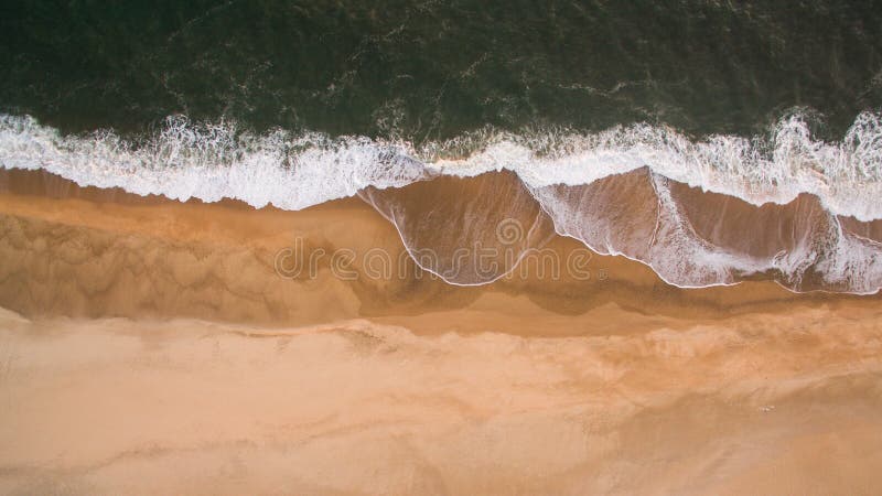Aerial view of ocean sea waves on sandy beach at evening stock images Aerial view of ocean sea waves on sandy beach at evening stock images